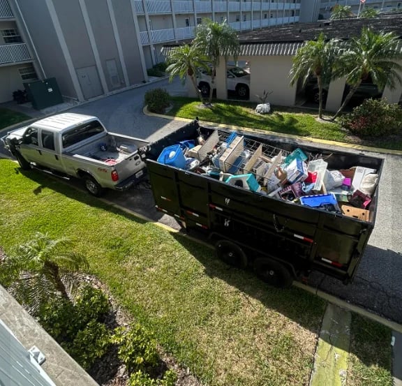 Junk removal Tampa Bay - After condo unit cleanout in Tampa Bay area, pickup truck and trailer filled with household items